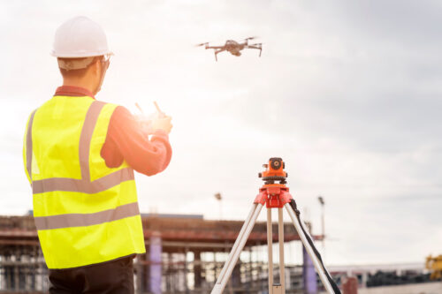 Engineer,Working,At,Construction,Site,With,Drone,Over,Construction,Site.